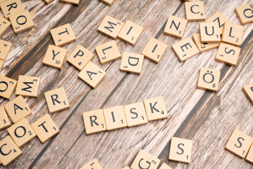 The word RISK made of wooden word tiles.